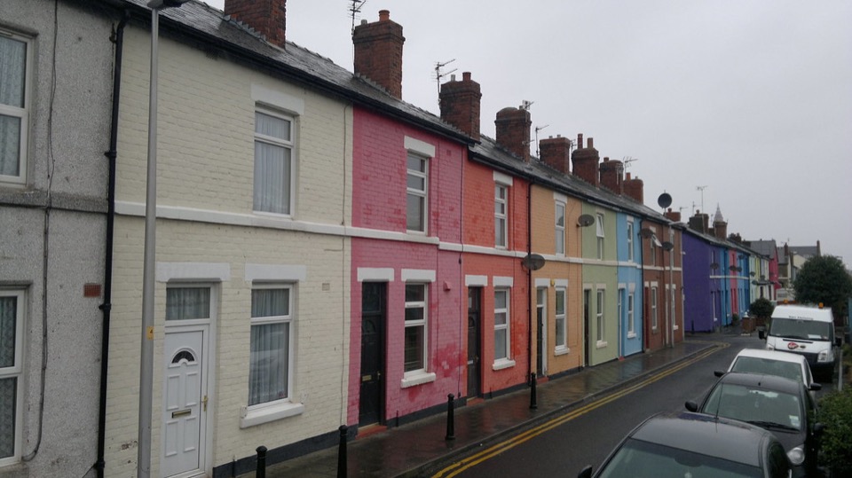 A row of painted render terraced houses in the rain at Blackpool